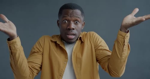 Slow Motion Portrait of Confused and Desperate Man Spreading Arms and Shaking Head After Bad