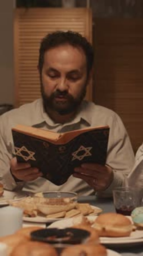 Jewish Man Reading Torah Aloud at Hanukkah Feast