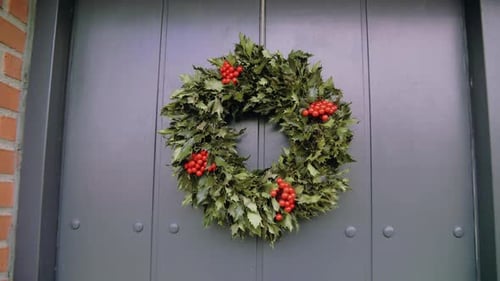 Christmas Wreath on Gray Door of Brick Home