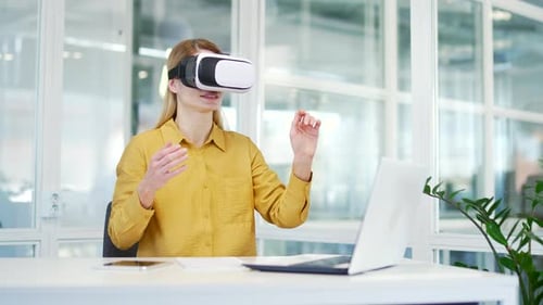 Woman Using VR Headset in Modern Office