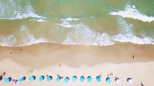Mediterranean beach during summer with people in the water