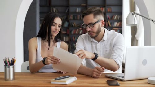 Collaborative Young Adults Working Together at Desk Indoors