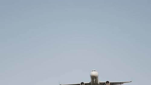 Airplane Flying Overhead to Land at Airport in Slow Motion