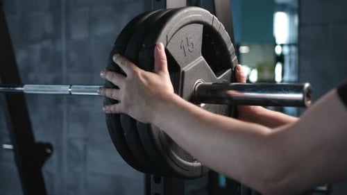 Close Up of Handsome Male Prepare to Do Exercises with Barbell in a Gym