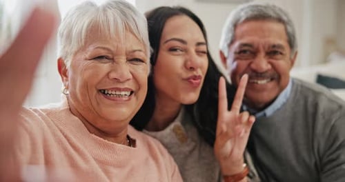 Family selfie, woman and senior parents in a living room with peace, hands and bonding