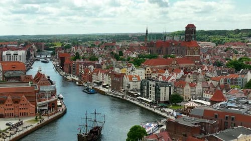 Aerial view of Gdańsk's historic waterfront, showcasing the iconic St. Mary's Church, traditional bu