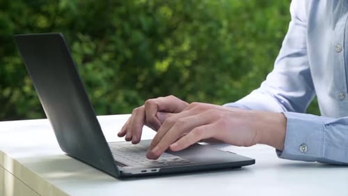 Nahaufnahme von Händen, die gekonnt auf einer Laptoptastatur tippen