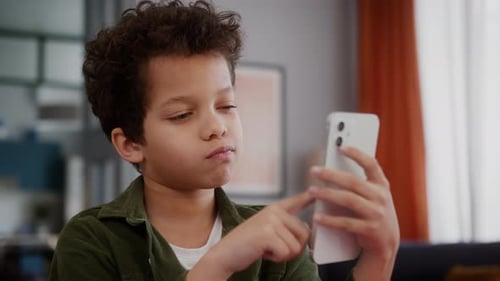 Child Using Cellphone Indoors