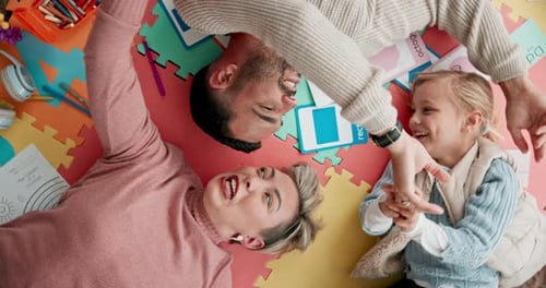 Top view, play and parents with child on floor for bonding, healthy relationship