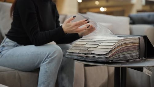 A Customer Chooses a Color in a Furniture Store Discounts on Goods Black Friday