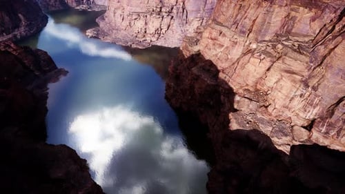 River Flowing Through a Majestic Canyon with Towering Mountains