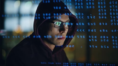 Focused Man Coding in Dark Urban Office