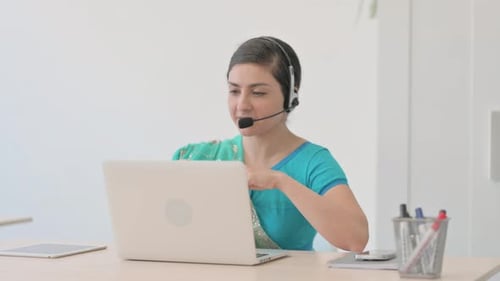 Indian Woman in Sari with Headset Talking with Customers Online in Call Center