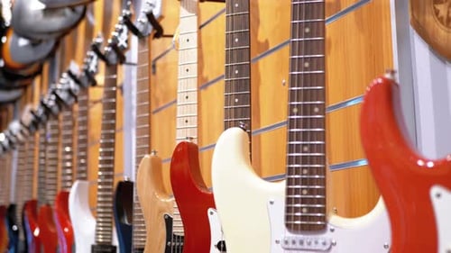 Lot of Electric Guitars Hanging in a Music Store Shop Musical Instruments