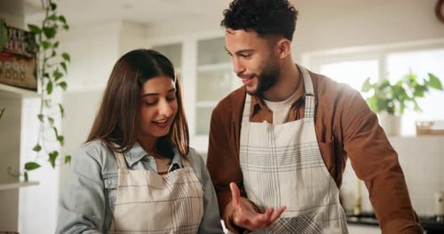 Young Couple Cooking Together in Bright Kitchen