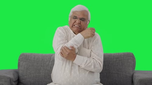Sick Indian old man suffering from arthritis Green screen