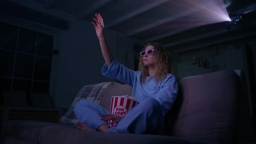 Woman Wearing 3D Glasses Watching Projector at Home