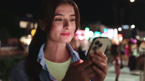 Closeup View Portrait of Cute Young Caucasian Woman Holding and Looking at Smartphone Typing