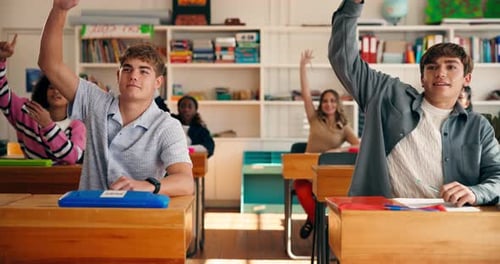 Enthusiastic Teenage Students Raising Hands in Classroom