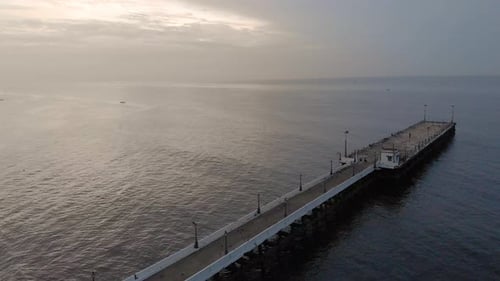 4k Aerial Dolly shot of a Shipping Port Pier on a Sunrise with monsoon clouds covered near Rock Beac