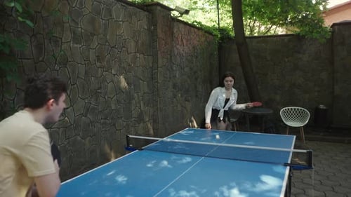 Young Adults Playing Table Tennis in Urban Setting