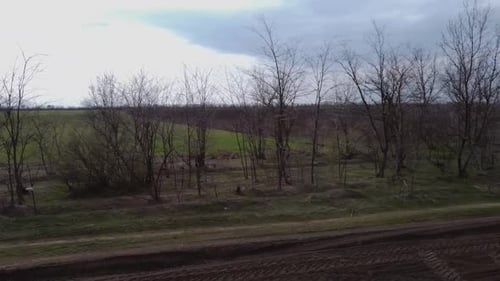 Blue tractor OA working on the field in Ukraine