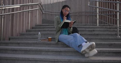 Young Adult Studying Outside in the City