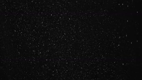 White Dust Particles Floating on Black Background