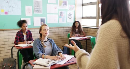 Teenagers in Classroom Listening to Teacher Lesson