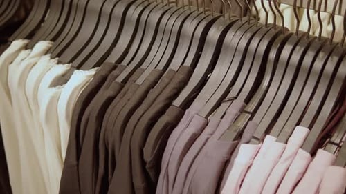 Row of Assorted Clothing on Hangers in Store