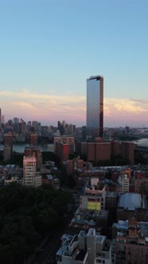 Vertical Aerial Perspective of East Houston Street with Iconic Midtown Manhattan Skyline Background