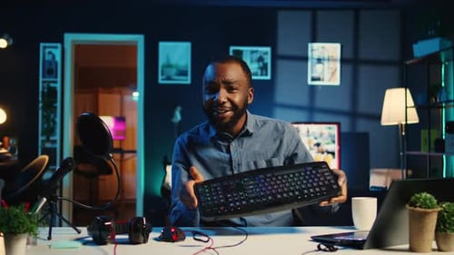 Man Reviews Computer Gear at Home at Night