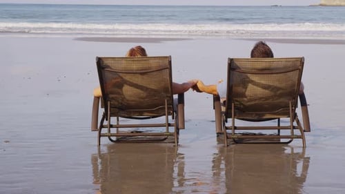Romantic caucasian couple holding hands on a tropical costa rica beach vacation