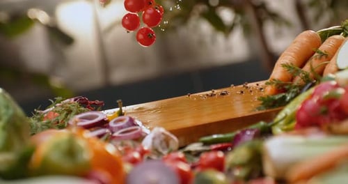 Cherry tomatoes dropping on a wood