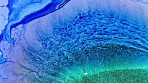 Close-up of blue ink diffusing in water creating an abstract art effect