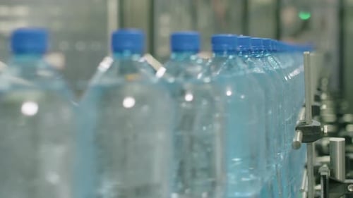 PET Bottles with Pure Water Moving on Automatic Conveyor Line