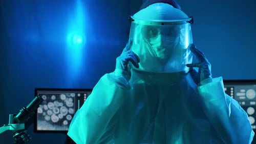 Scientist Prepares Microscope in Blue Laboratory