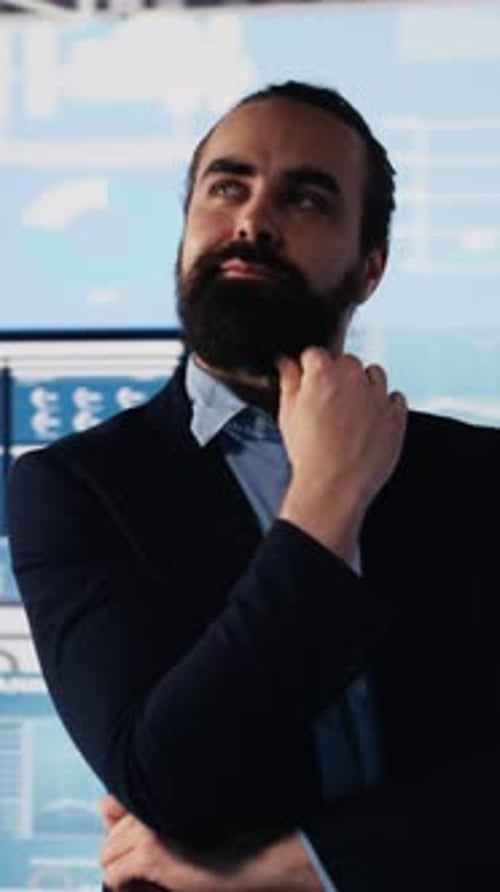 Man Contemplates Stock Market Data in Office