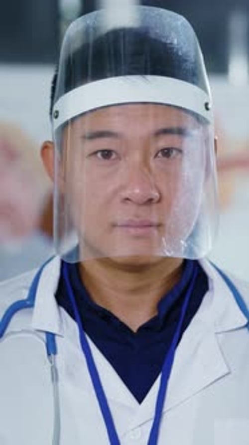 Medical Professional Wearing Face Shield Looking at Camera