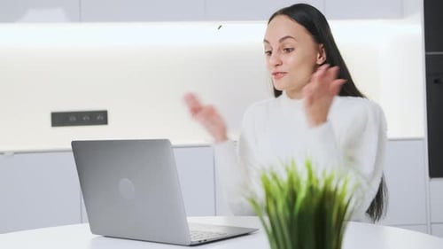 Woman Using Laptop in Modern Bright Kitchen