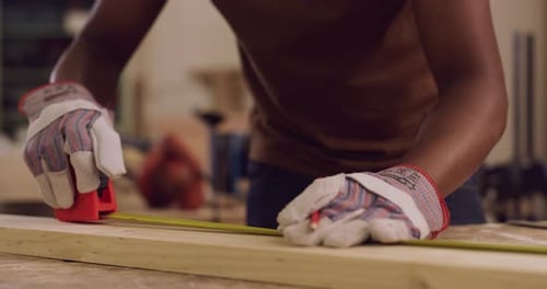 4k video footage of a construction worker measuring pieces in his workshop