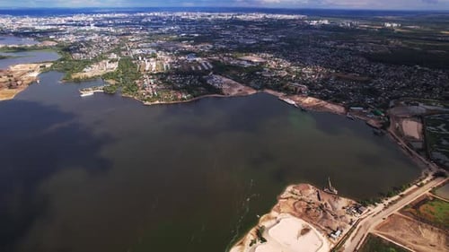 Town Buildings and Sand Washing Pit on Bank of River Harbor