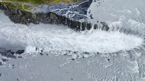 Aerial drone view of Dettifoss waterfall plunging into Jokulsargljufur canyon in Northeast Iceland.