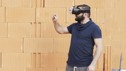 Man wearing VR headset interacts with virtual environment