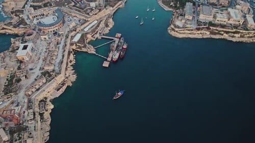 Aerial view of people jumping off the boat in La Valletta, Malta.