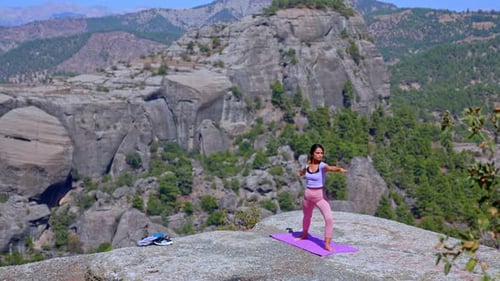 Woman Practicing Yoga Stretch in Nature with Mountain View Outdoors