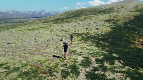Two Athletes Men Run on Trail on Mountain Plateau