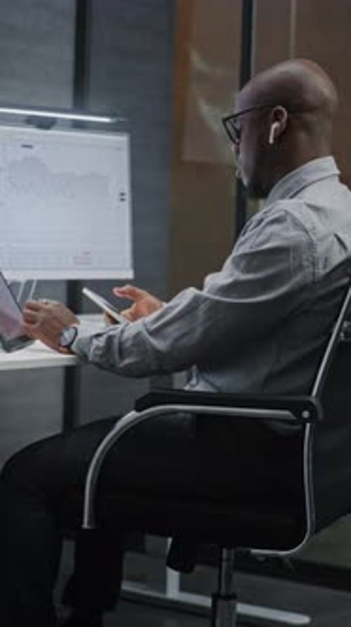 Adult Working At Desk Using Technology