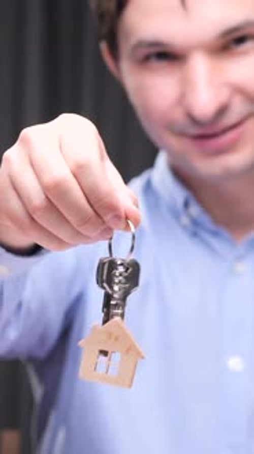 Vertical Video Real Estate Agent Holding Keys with House Keychain
