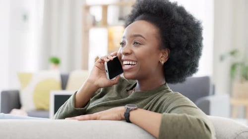 Happy Woman Talking on Mobile Phone at Home